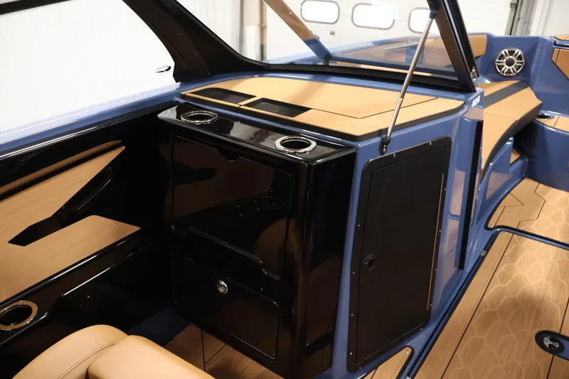 Slide: The Image of 2026 Yamaha Boats 222XD interior with sleek black and tan design, featuring cup holders. - 31