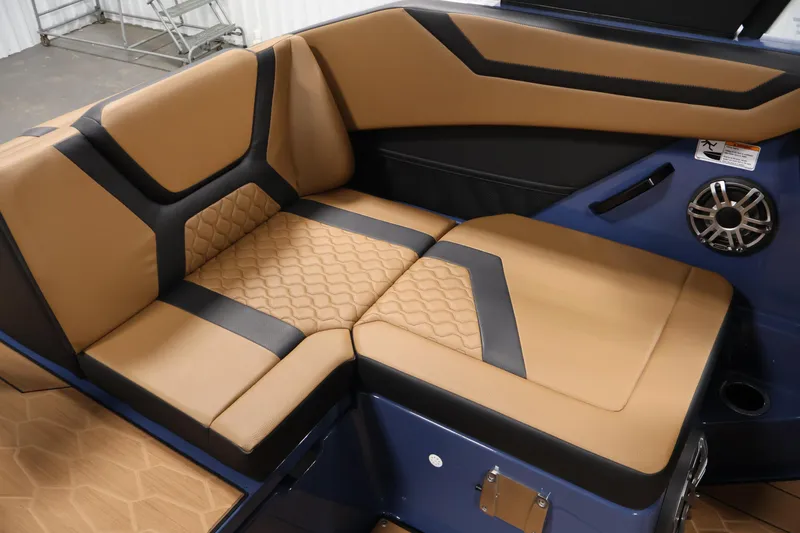 Slide: The Image of 2026 Yamaha Boats 222XD interior with tan and black seating, featuring modern design and speaker. - 34