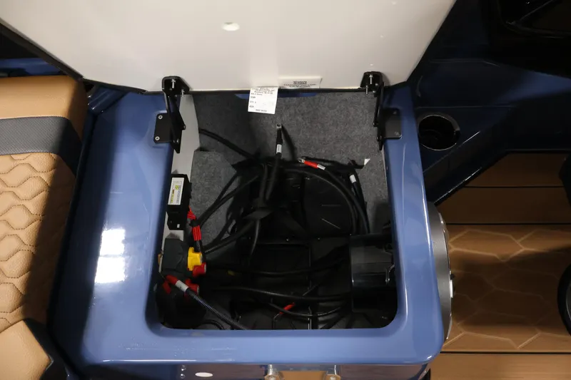 Slide: The Image of Open storage compartment in 2026 Yamaha Boats 222XD, showing cables and interior details. - 35
