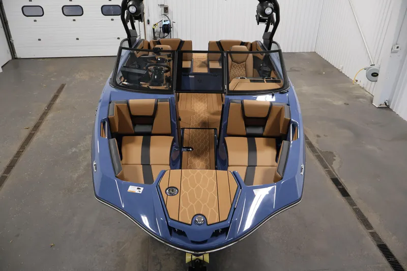 Slide: The Image of 2026 Yamaha Boats 222XD interior with tan and black seating, in a showroom setting. - 8