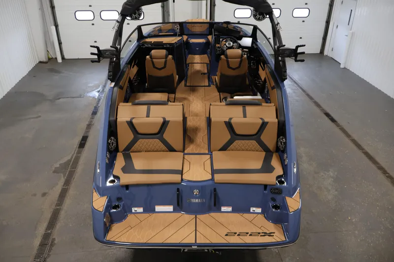 Slide: The Image of 2026 Yamaha Boats 222XD interior, featuring luxurious seating and modern design in a showroom setting. - 9