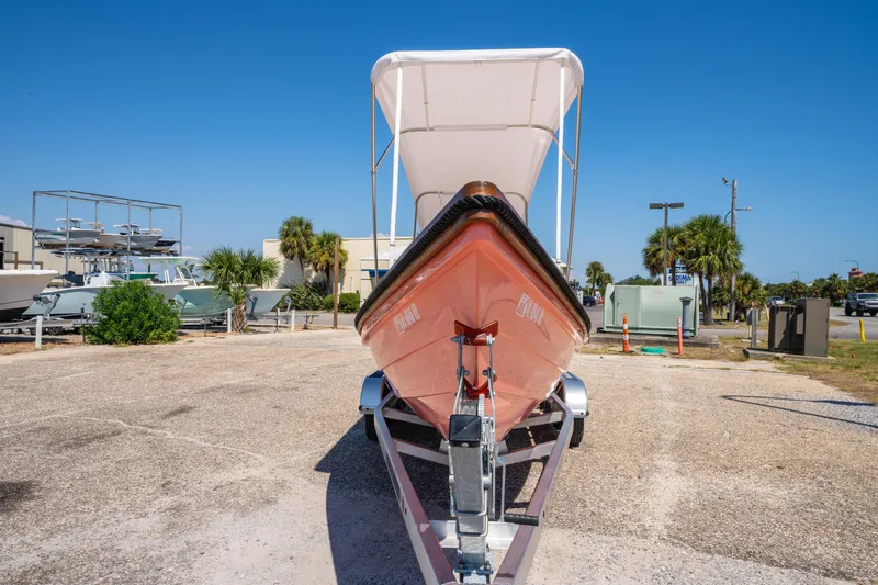 Slide: The Image of 2025 Caribiana Maracas 23 Skiff on trailer, sunny outdoor setting. - 12