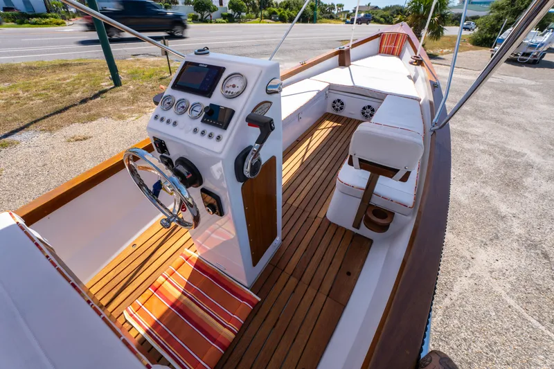 Slide: The Image of 2025 Caribiana Maracas 23 Skiff with wooden deck and modern control panel. - 16