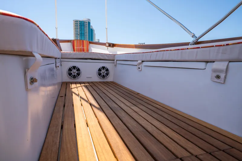 Slide: The Image of 2025 Caribiana Maracas 23 Skiff interior with wooden deck and modern design. - 22