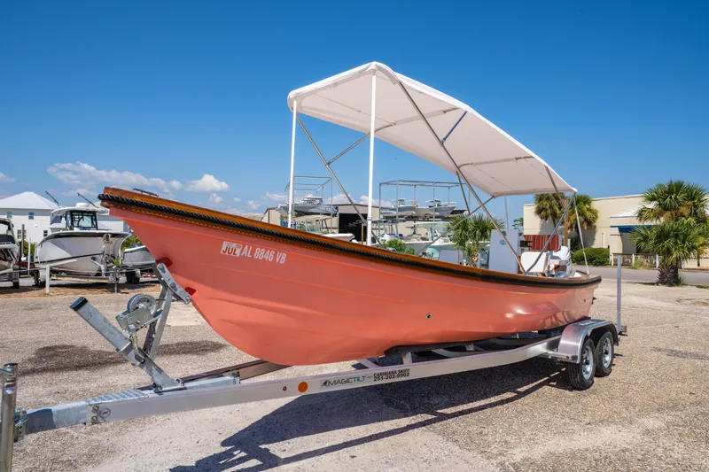Slide: The Image of 2025 Caribiana Maracas 23 Skiff on trailer, featuring a canopy, parked outdoors. - 4