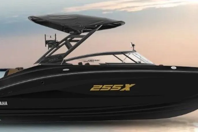 Slide: The Image of 2026 Yamaha Boats 255XD in black, sleek design against a serene sunset backdrop. - 7