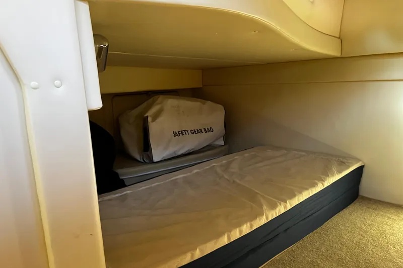 Slide: The Image of Interior cabin of 2008 Bayliner 320 with safety gear bag on bed. - 12