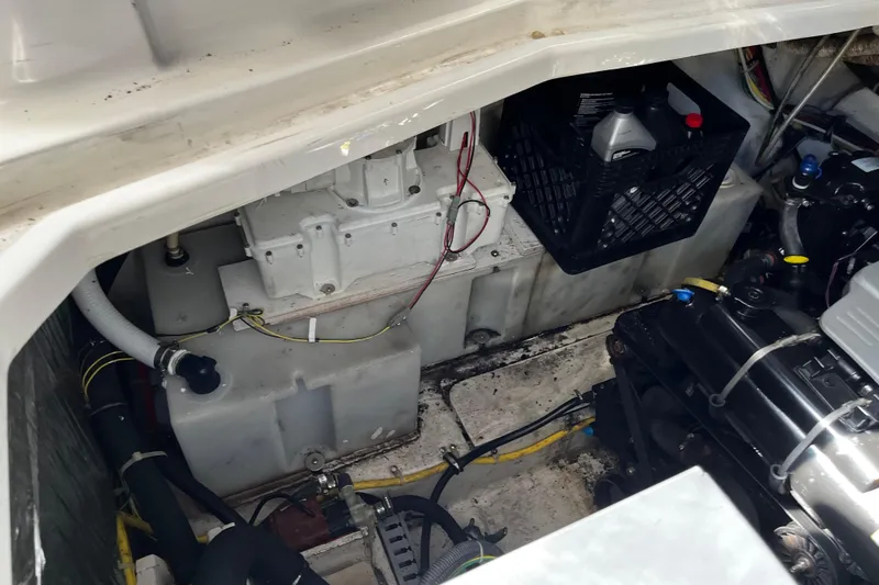 Slide: The Image of Engine compartment of a 2008 Bayliner 320 boat, showing mechanical components and storage. - 18