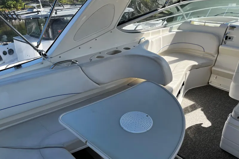 Slide: The Image of 2008 Bayliner 320 boat interior with seating and table, featuring sleek design and comfort. - 3
