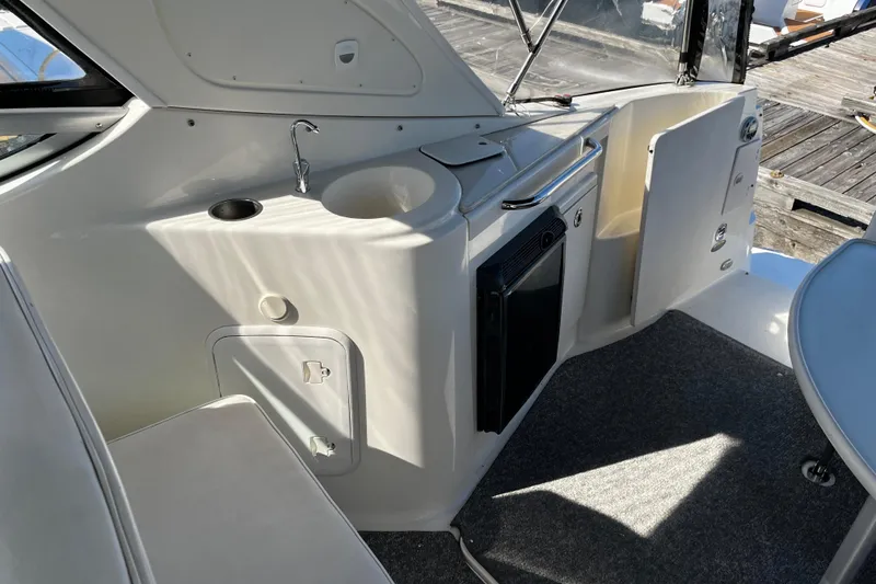 Slide: The Image of 2008 Bayliner 320 boat interior with kitchenette, sink, and storage compartments. - 4