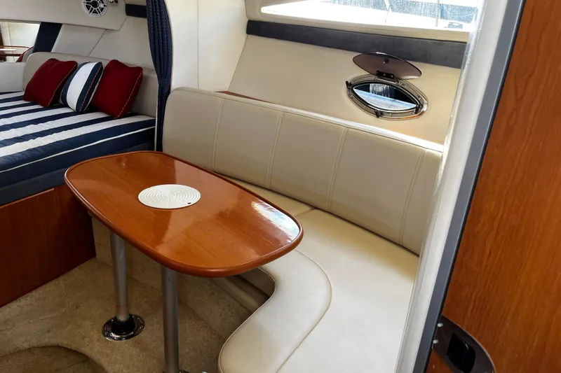 Slide: The Image of Interior of 2008 Bayliner 320 yacht with cozy seating and elegant wooden table. - 7
