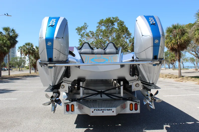Slide: The Image of 2025 Fountain 34 Thundercat boat with dual outboard engines, parked near palm trees. - 10