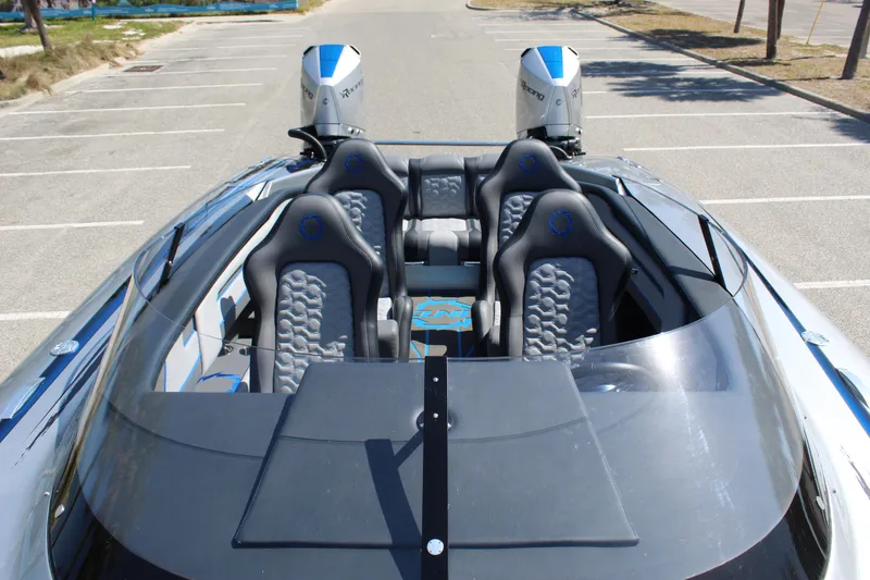 Slide: The Image of 2025 Fountain 34 Thundercat boat with sleek design and dual engines in a parking area. - 13