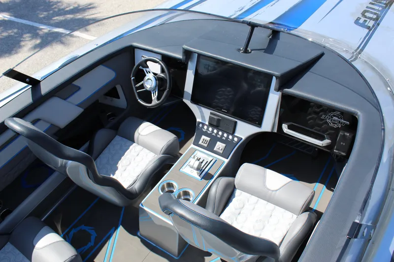 Slide: The Image of Interior of 2025 Fountain 34 Thundercat boat with modern dashboard and seating. - 26