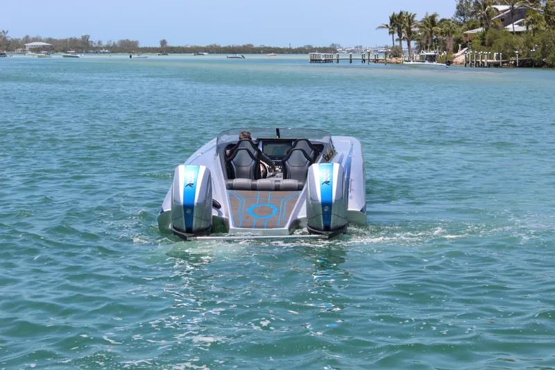 Slide: The Image of 2025 Fountain 34 Thundercat powerboat cruising on a sunny, tropical waterway. - 33