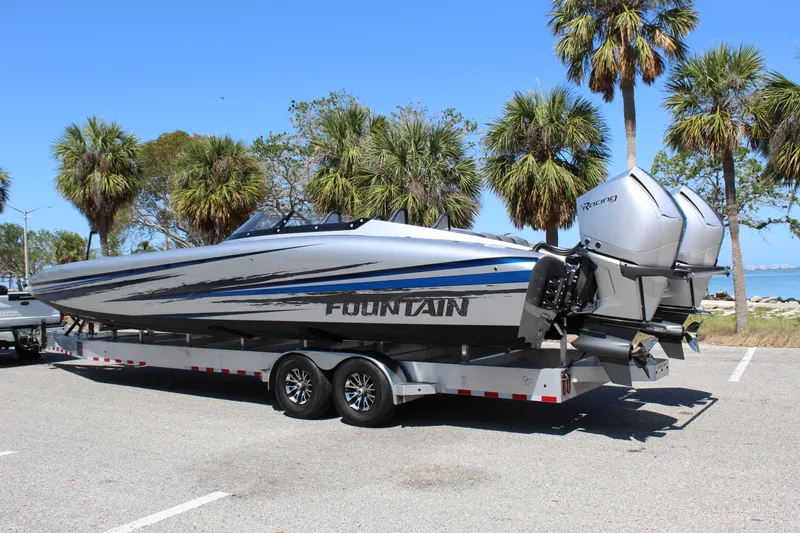 Slide: The Image of 2025 Fountain 34 Thundercat boat on trailer, parked near palm trees. - 4