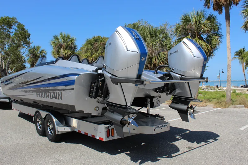 Slide: The Image of 2025 Fountain 34 Thundercat boat on trailer, dual engines, parked near palm trees. - 5