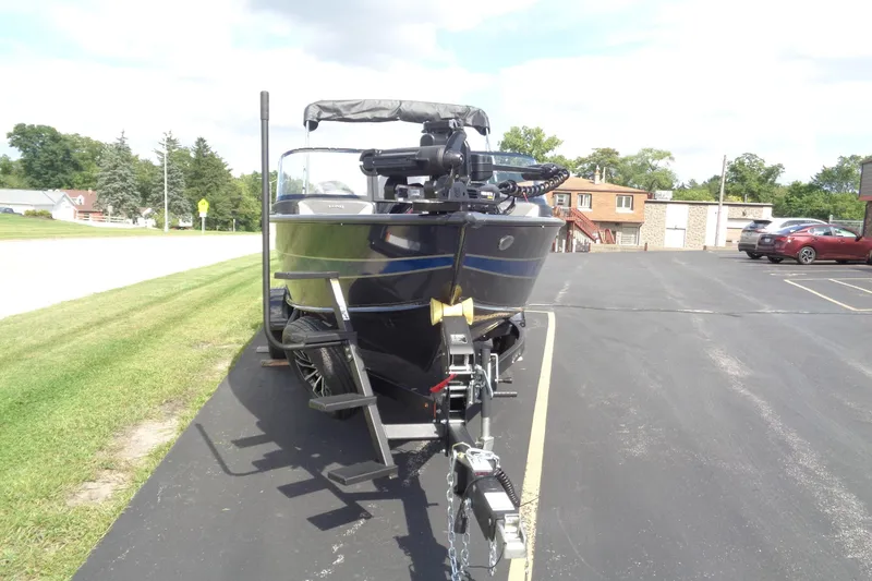 Slide: The Image of 2026 Lund 1875 Crossover XS boat on trailer in parking lot. - 9