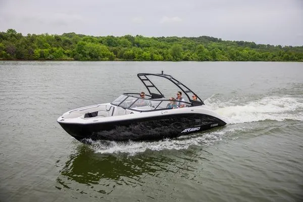 Slide: The Image of 2026 Yamaha Boats AR250 cruising on a lake with lush green shoreline. - 4