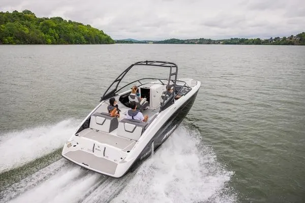 Slide: The Image of 2026 Yamaha Boats AR250 cruising on a lake with passengers, surrounded by lush greenery. - 6