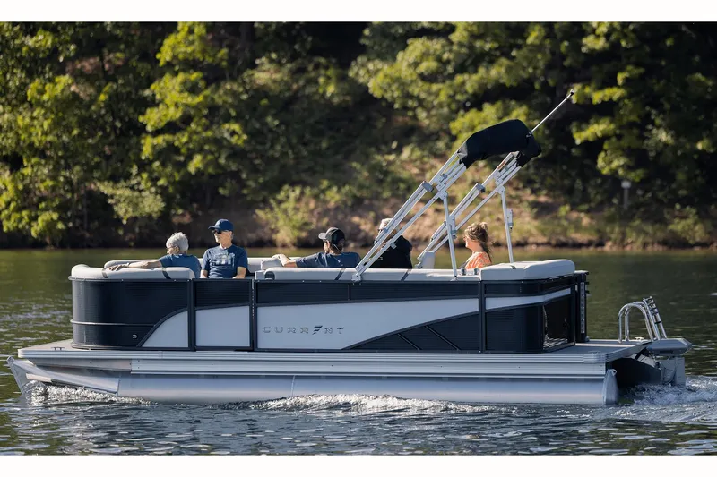 Slide: The Image of Manufacturer Provided Image: 2023 Crest CURRENT pontoon boat cruising on a lake with passengers. - 1