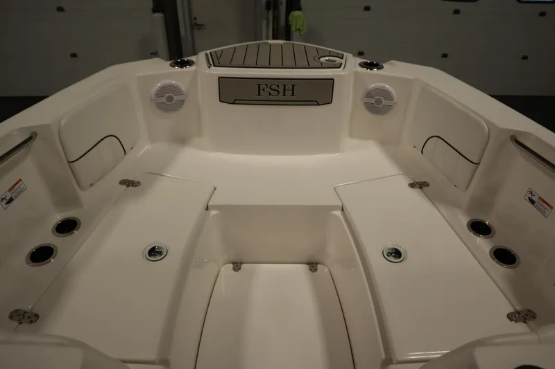 Slide: The Image of 2026 Yamaha Boats 220 FSH Sport interior with seating and cup holders. - 10