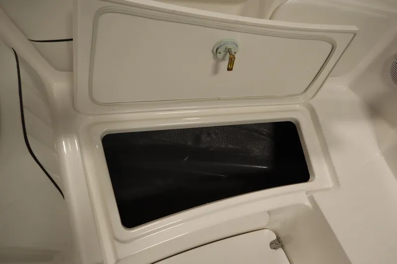 Slide: The Image of 2026 Yamaha Boats 220 FSH Sport storage compartment with secure latch. - 14