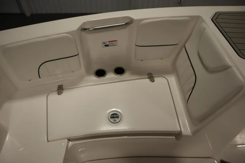 Slide: The Image of 2026 Yamaha Boats 220 FSH Sport interior seating and storage area. - 15