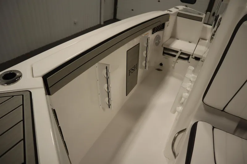 Slide: The Image of 2026 Yamaha Boats 220 FSH Sport interior, featuring sleek seating and storage compartments. - 24