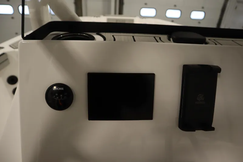 Slide: The Image of 2026 Yamaha Boats 220 FSH Sport dashboard with compass and control panel. - 29