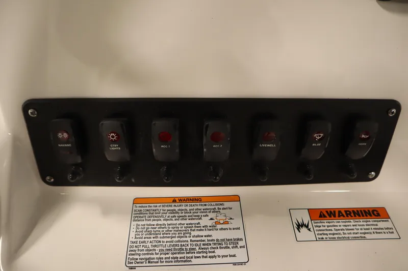 Slide: The Image of Control panel of 2026 Yamaha Boats 220 FSH Sport with labeled switches and warning labels. - 30