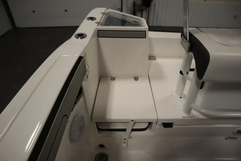 Slide: The Image of 2026 Yamaha Boats 220 FSH Sport interior seating and storage area. - 40