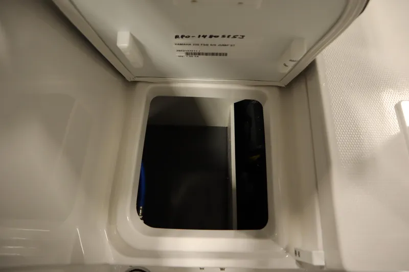 Slide: The Image of 2026 Yamaha Boats 220 FSH Sport storage compartment interior view. - 42