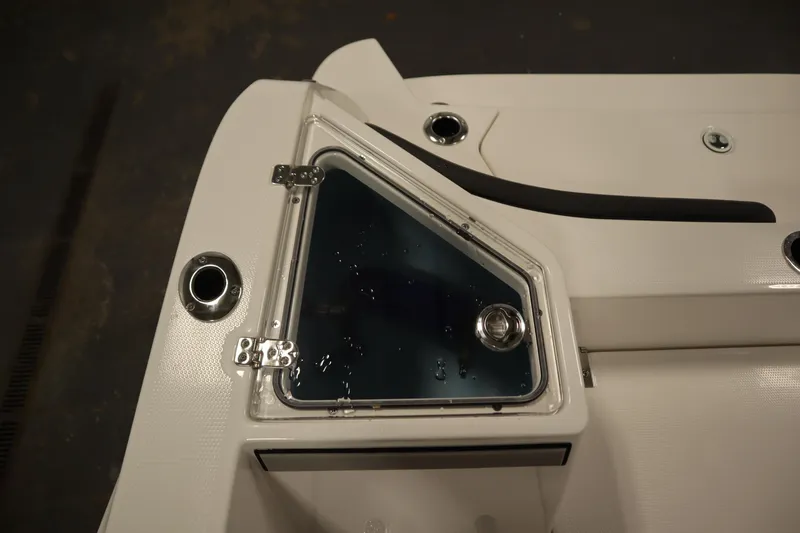 Slide: The Image of 2026 Yamaha Boats 220 FSH Sport deck detail with storage compartment and stainless steel fittings. - 43