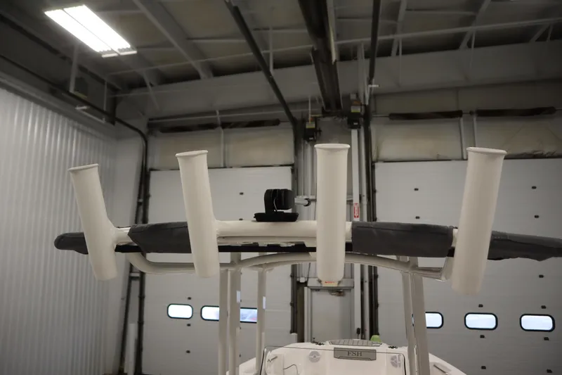Slide: The Image of 2026 Yamaha Boats 220 FSH Sport fishing rod holders in a garage setting. - 44