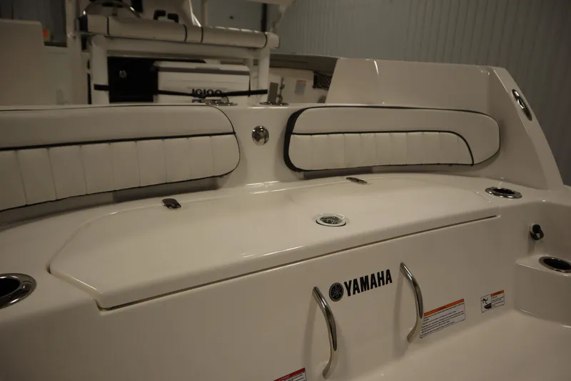 Slide: The Image of 2026 Yamaha Boats 220 FSH Sport interior with seating and storage features. - 45