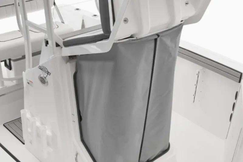 Slide: The Image of 2026 Yamaha Boats 220 FSH Sport interior with gray seat cover and storage area. - 54