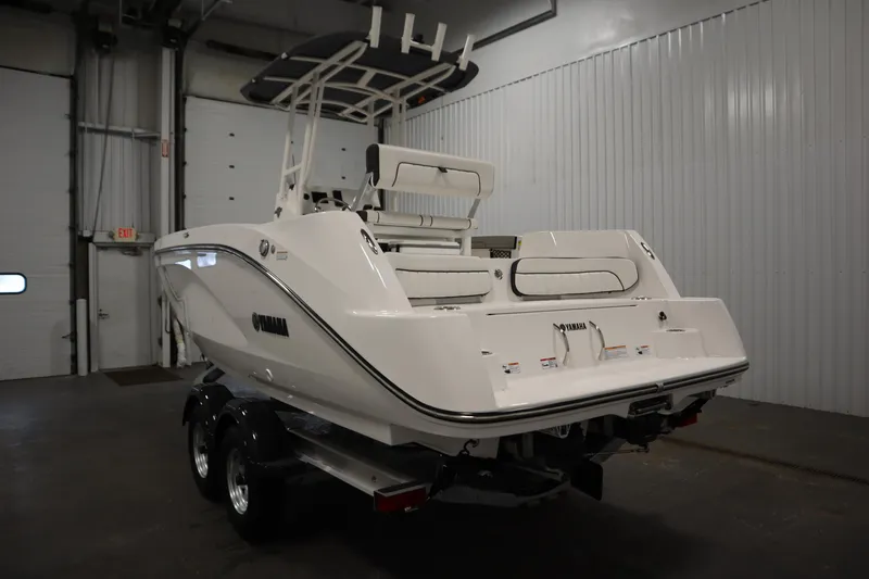 Slide: The Image of 2026 Yamaha Boats 220 FSH Sport in a garage, rear view. - 6