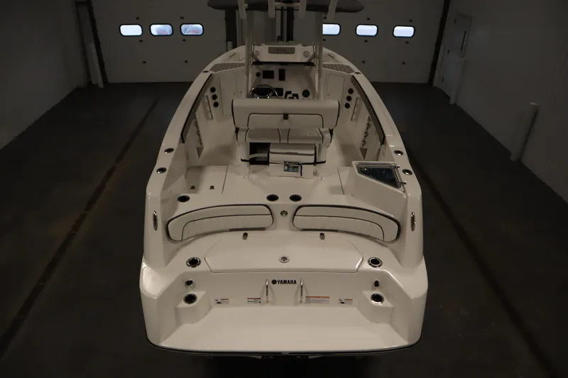 Slide: The Image of 2026 Yamaha Boats 220 FSH Sport, interior view in a garage setting. - 9