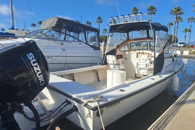The Image of 1997 Steiger Craft 21 Block Island boat docked with Suzuki outboard motor. - 1