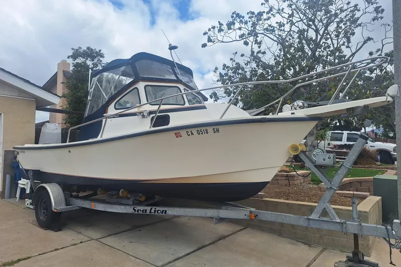 Slide: The Image of 1997 Steiger Craft 21 Block Island boat on trailer, parked in driveway. - 4