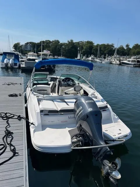 Slide: The Image of 2019 Regal 21 OBX boat docked at marina with Yamaha outboard motor. - 1