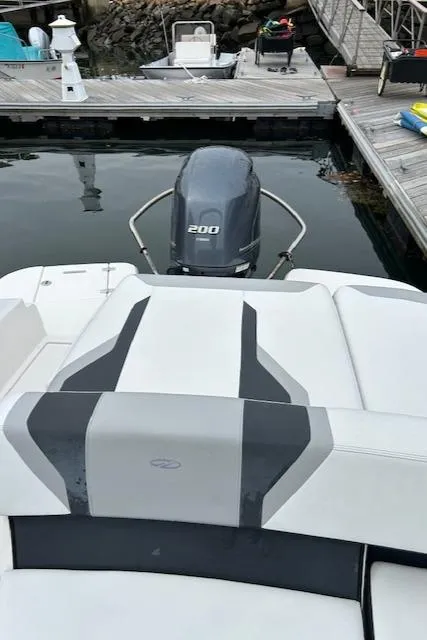 Slide: The Image of 2019 Regal 21 OBX boat with outboard motor docked at marina. - 12