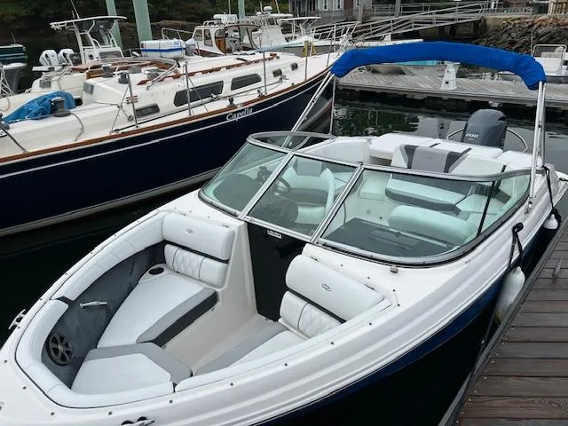 Slide: The Image of 2019 Regal 21 OBX boat docked, featuring sleek design and comfortable seating. - 3