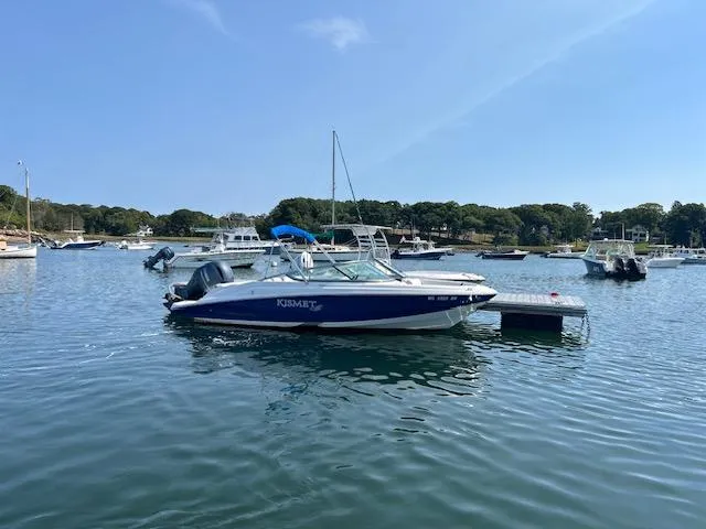 Slide: The Image of 2019 Regal 21 OBX boat docked in a serene marina setting. - 4