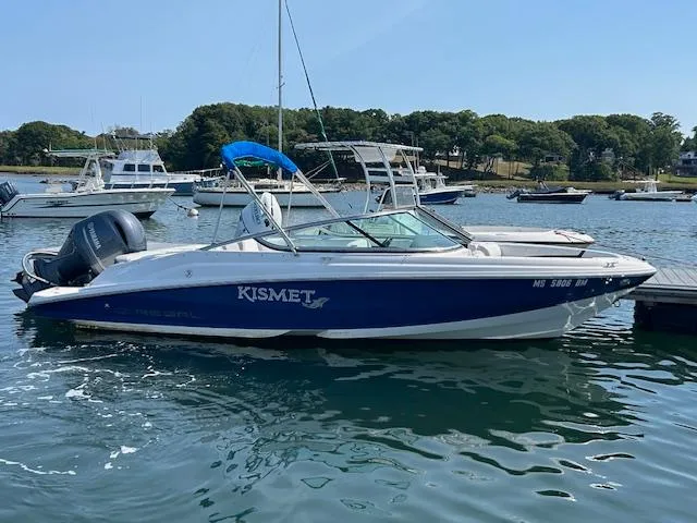 Slide: The Image of 2019 Regal 21 OBX boat docked in a marina with blue canopy. - 5