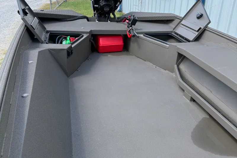 Slide: The Image of 2025 Alweld 1548 Invader boat interior with storage compartments and motor. - 11