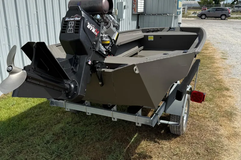 Slide: The Image of 2025 Alweld 1548 Invader boat on trailer, featuring a powerful motor. - 5