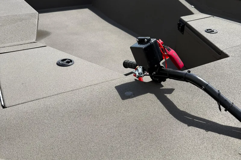 Slide: The Image of 2025 Alweld 1548 Invader boat interior with steering handle and storage compartments. - 7