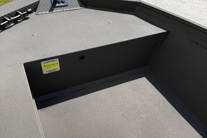 Slide: The Image of 2025 Alweld 1548 Invader boat interior, showcasing storage compartment and capacity label. - 9